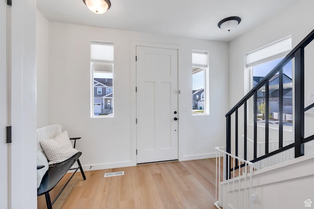 1167 S 1275 W, Clearfield, UT 84015 - foyer featuring stairway, baseboards, visible vents, and light wood-style flooring