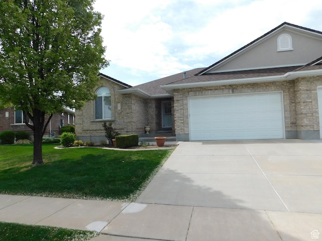 single story home with an attached garage, stone siding, a front yard, and concrete driveway