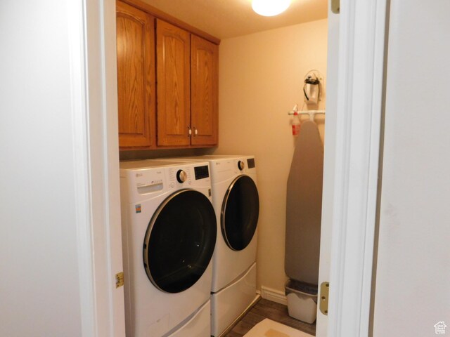 washroom with cabinet space and washer and dryer
