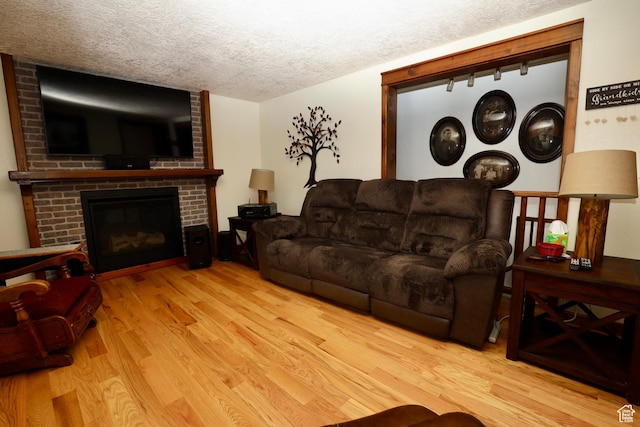 75 S Cooley St W, Grantsville, UT 84029 - living area with a brick fireplace, wood finished floors, and a textured ceiling