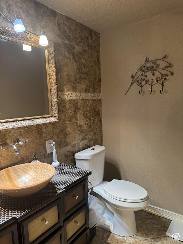 75 S Cooley St W, Grantsville, UT 84029 - bathroom with toilet, tile walls, baseboards, decorative backsplash, and vanity