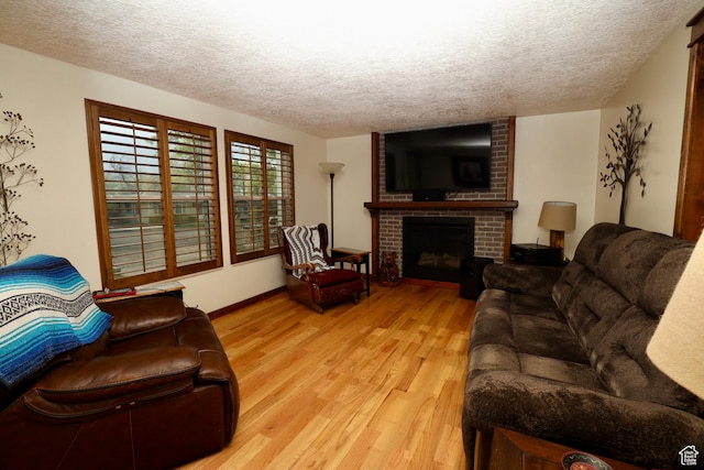 75 S Cooley St W, Grantsville, UT 84029 - living area with light wood-type flooring, a fireplace, baseboards, and a textured ceiling