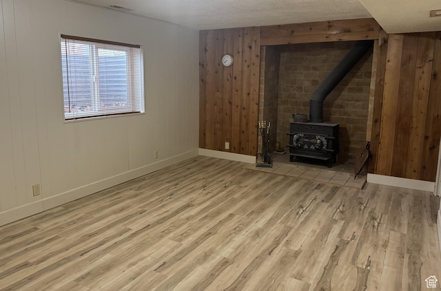 75 S Cooley St W, Grantsville, UT 84029 - unfurnished living room with visible vents, baseboards, wood finished floors, and a wood stove