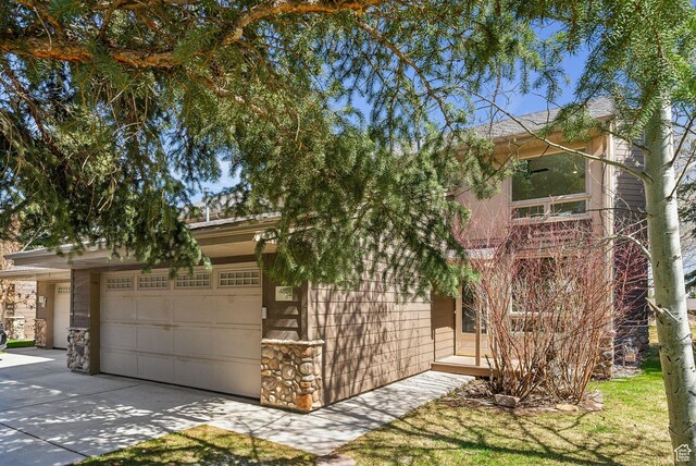 4824 N Meadow Loop Rd Unit 7, Park City, UT 84098 - obstructed view of property featuring a garage and concrete driveway