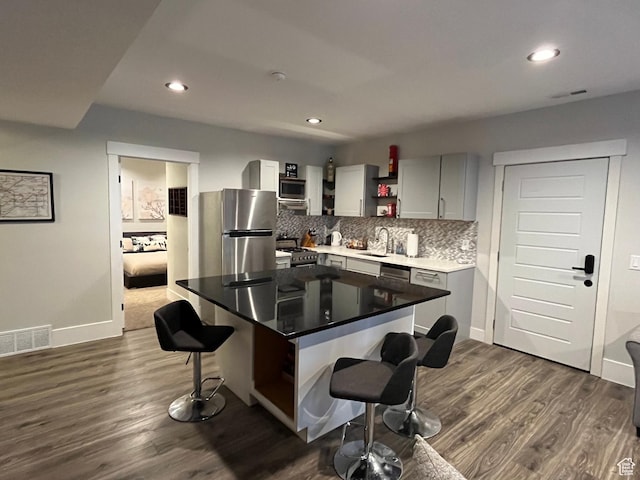 364 W Clark Cir, Farmington, UT 84025 - kitchen with stainless steel appliances, open shelves, a kitchen breakfast bar, a sink, and decorative backsplash