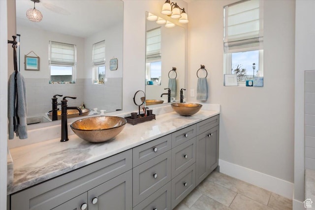 364 W Clark Cir, Farmington, UT 84025 - full bath featuring double vanity, plenty of natural light, tile patterned floors, and baseboards