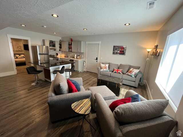 364 W Clark Cir, Farmington, UT 84025 - living room featuring a textured ceiling, dark wood-type flooring, baseboards, and recessed lighting