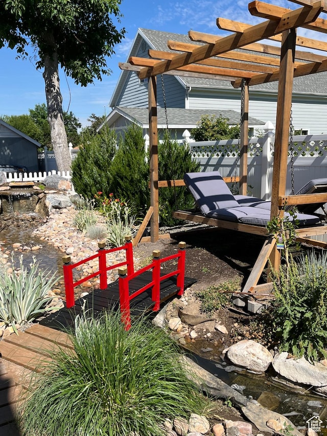 364 W Clark Cir, Farmington, UT 84025 - view of yard featuring a pergola, a wooden deck, and a garden pond