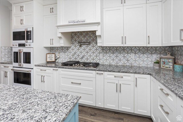 364 W Clark Cir, Farmington, UT 84025 - kitchen featuring stainless steel appliances, white cabinets, backsplash, light stone counters, and dark wood finished floors
