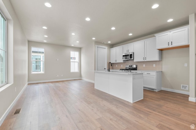 3903 W Red Clover Dr, Lehi, UT 84043 - kitchen with visible vents, a sink, baseboards, tasteful backsplash, and appliances with stainless steel finishes