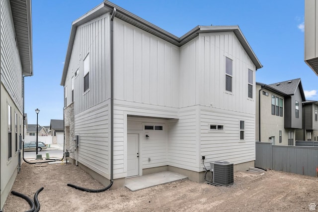 3903 W Red Clover Dr, Lehi, UT 84043 - rear view of property featuring board and batten siding, fence, and central air condition unit