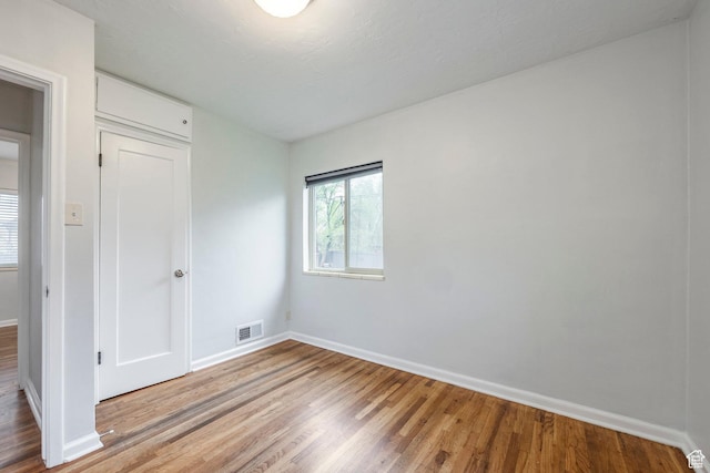 1425 W Riverside Cir, Salt Lake City, UT 84116 - spare room with baseboards, wood finished floors, and visible vents