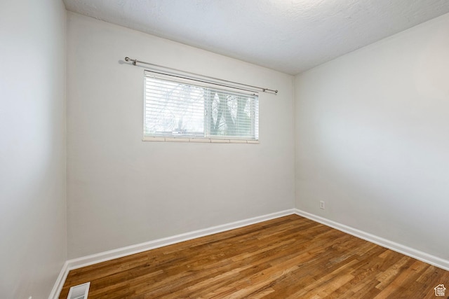 1425 W Riverside Cir, Salt Lake City, UT 84116 - empty room with baseboards, wood finished floors, and visible vents