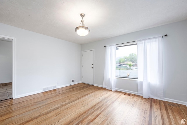 1425 W Riverside Cir, Salt Lake City, UT 84116 - spare room featuring wood finished floors, visible vents, and baseboards