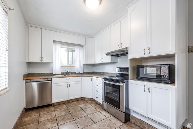 1425 W Riverside Cir, Salt Lake City, UT 84116 - kitchen with white cabinets, under cabinet range hood, stainless steel appliances, and a sink