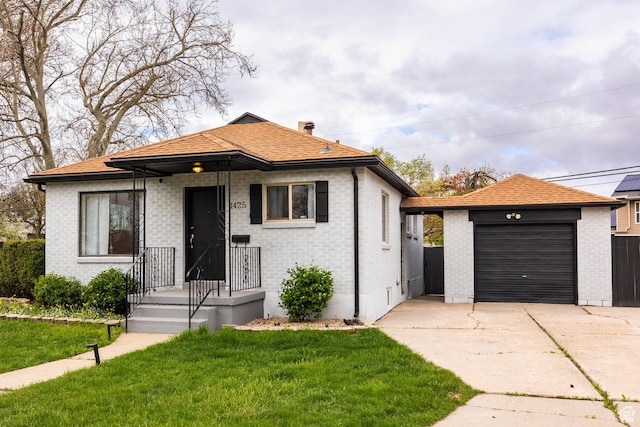 1425 W Riverside Cir, Salt Lake City, UT 84116 - view of front of home with concrete driveway, a front lawn, brick siding, and a shingled roof