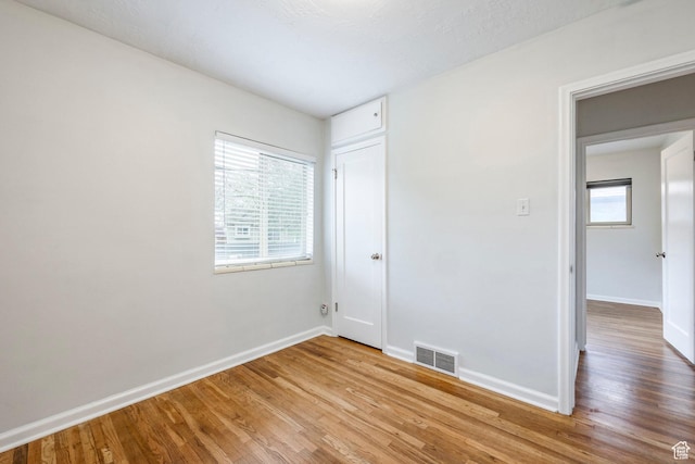 1425 W Riverside Cir, Salt Lake City, UT 84116 - spare room featuring baseboards, wood finished floors, and visible vents