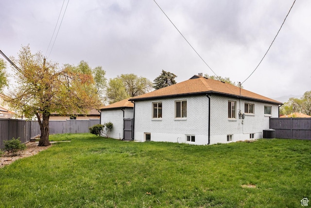 1425 W Riverside Cir, Salt Lake City, UT 84116 - back of property with a yard, central air condition unit, and a fenced backyard