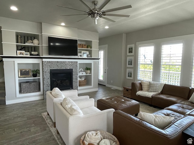 living area featuring recessed lighting, wood finished floors, a fireplace, baseboards, and a ceiling fan