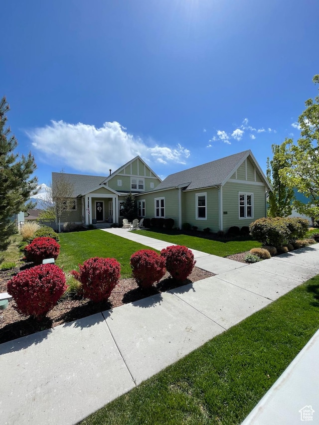 view of front of house with a front yard and concrete driveway