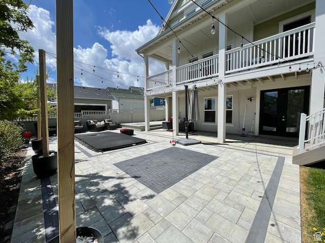 view of home's community with fence, outdoor lounge area, and a patio