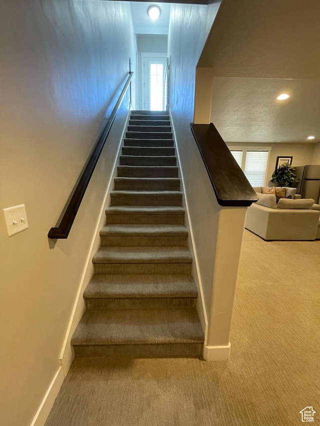 stairs featuring recessed lighting, carpet, and baseboards