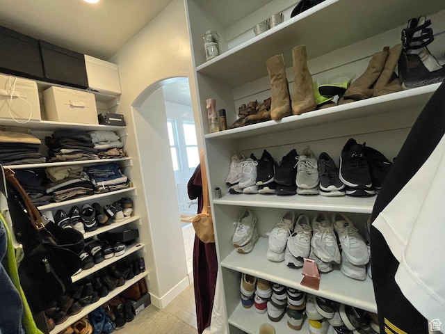 spacious closet featuring arched walkways