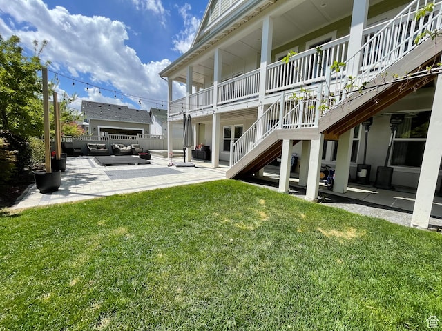 view of yard featuring outdoor lounge area, stairway, a patio, and fence