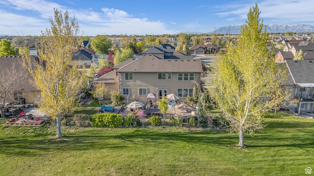 3627 W Augusta Dr, Syracuse, UT 84075 - back of property featuring a residential view, stucco siding, a yard, and a mountain view