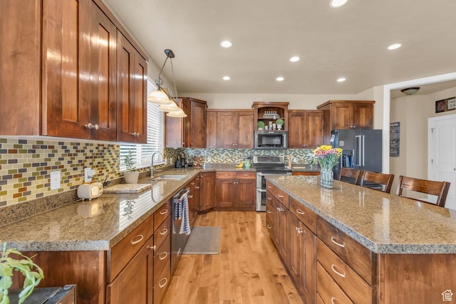 3627 W Augusta Dr, Syracuse, UT 84075 - kitchen featuring appliances with stainless steel finishes, a sink, open shelves, a kitchen island, and light wood finished floors