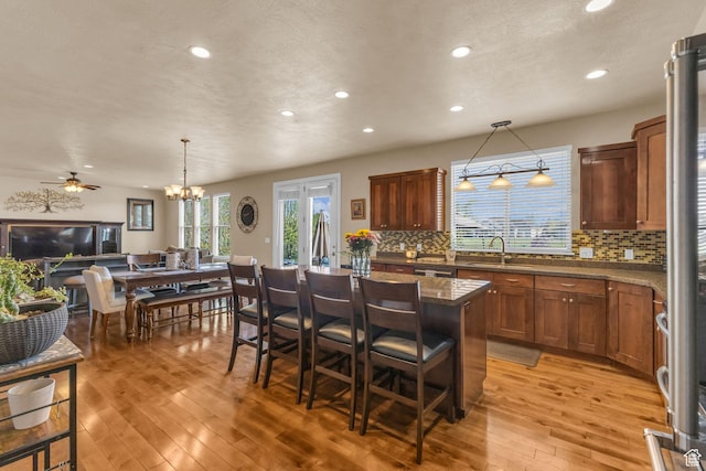 3627 W Augusta Dr, Syracuse, UT 84075 - kitchen with a sink, recessed lighting, light wood-style floors, tasteful backsplash, and a kitchen island