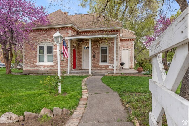 290 N 300 E, Springville, UT 84663 - view of front of house with brick siding, roof with shingles, and a front yard