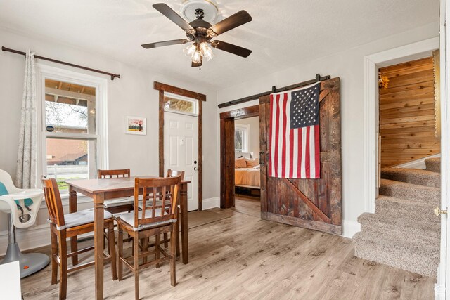 290 N 300 E, Springville, UT 84663 - dining space featuring a barn door, stairway, light wood-type flooring, and ceiling fan