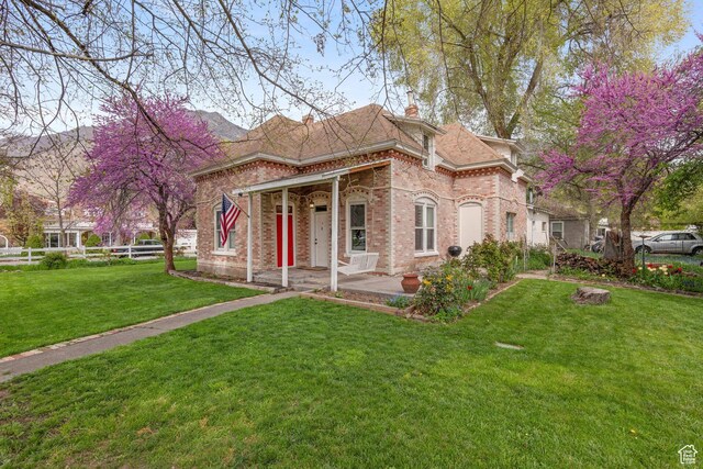 290 N 300 E, Springville, UT 84663 - view of front of property with a chimney, brick siding, fence, and a front yard
