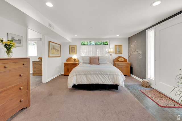 bedroom with baseboards, recessed lighting, and light colored carpet