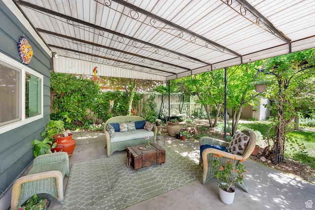 view of patio featuring an outdoor hangout area, a fenced backyard, a storage unit, and an outbuilding