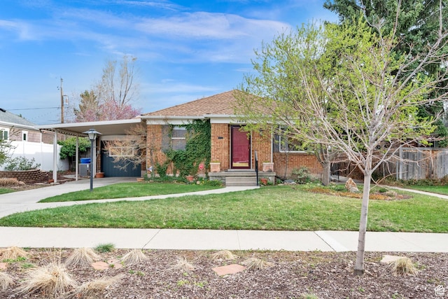 view of front of property featuring brick siding, an attached carport, and driveway