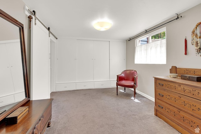 living area featuring a barn door and light colored carpet