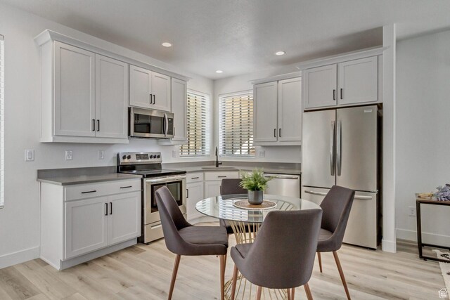 6807 W S Jordan Pkwy S Unit 251, South Jordan, UT 84009 - kitchen featuring a sink, appliances with stainless steel finishes, light wood-style floors, and recessed lighting