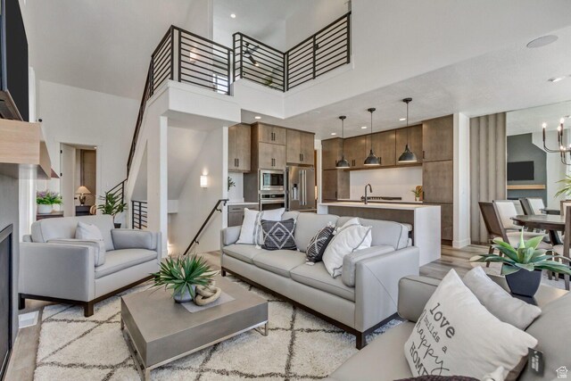 6807 W S Jordan Pkwy S Unit 251, South Jordan, UT 84009 - living area featuring a towering ceiling, recessed lighting, and a chandelier