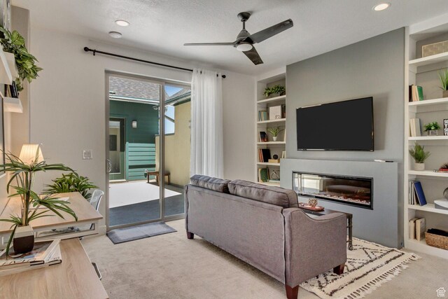 6807 W S Jordan Pkwy S Unit 251, South Jordan, UT 84009 - living area featuring recessed lighting, carpet, a ceiling fan, a glass covered fireplace, and built in features