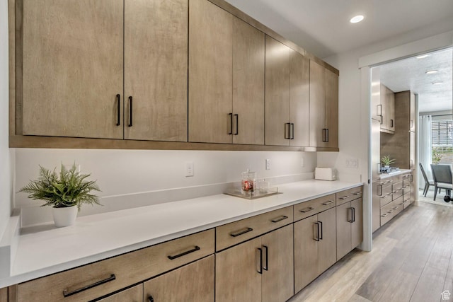 kitchen with light countertops, light wood-style floors, and recessed lighting