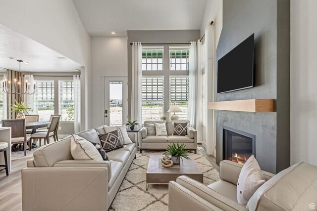 6807 W S Jordan Pkwy S Unit 251, South Jordan, UT 84009 - living room with wood finished floors, recessed lighting, a chandelier, and a high end fireplace