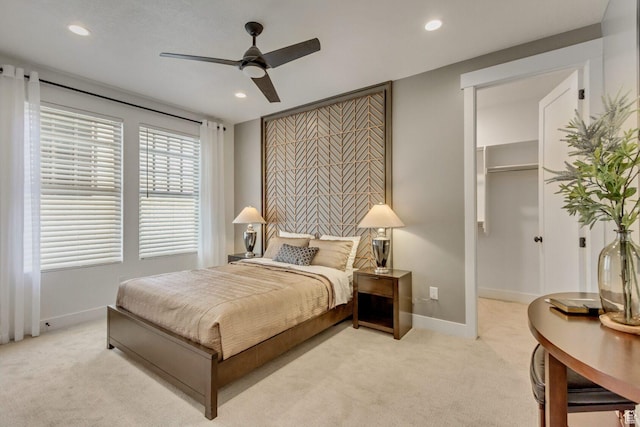 bedroom featuring recessed lighting, baseboards, a spacious closet, and light colored carpet