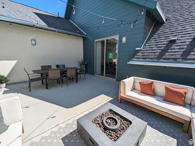 view of patio with an outdoor living space with a fire pit and outdoor dining space