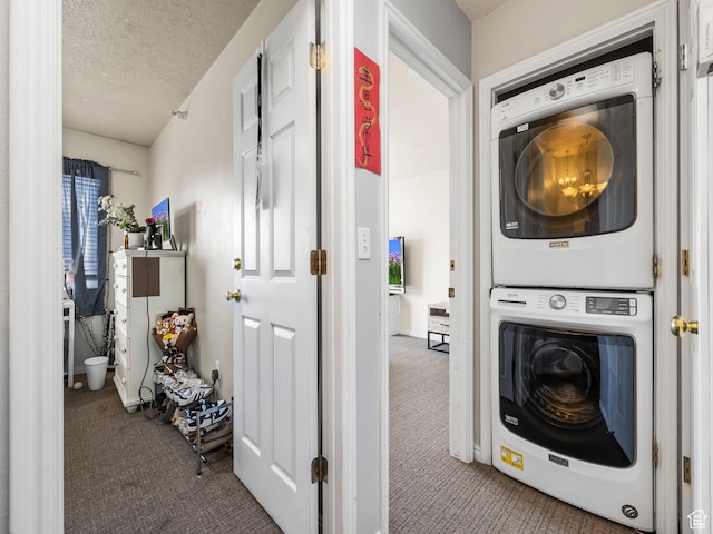 112 W Cougar Blvd N Unit 311, Provo, UT 84604 - clothes washing area featuring stacked washer / drying machine, carpet flooring, and a textured ceiling