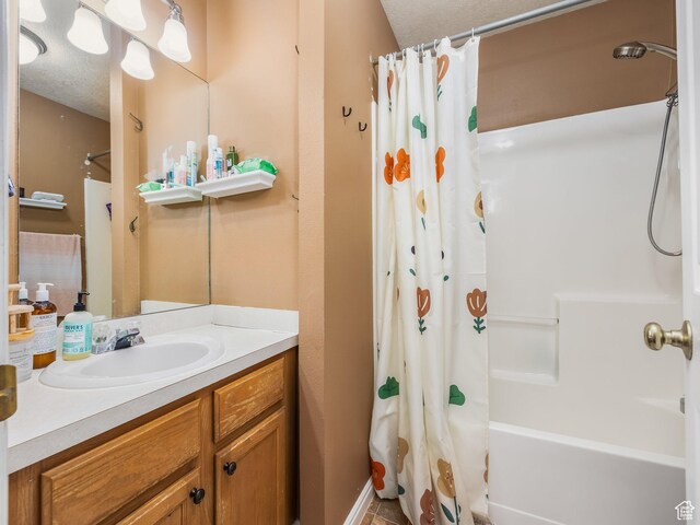 112 W Cougar Blvd N Unit 311, Provo, UT 84604 - bathroom with vanity, shower / bathtub combination with curtain, and a textured ceiling