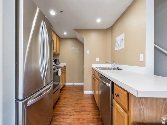 112 W Cougar Blvd N Unit 311, Provo, UT 84604 - kitchen with dark wood-style flooring, appliances with stainless steel finishes, a sink, light countertops, and a peninsula