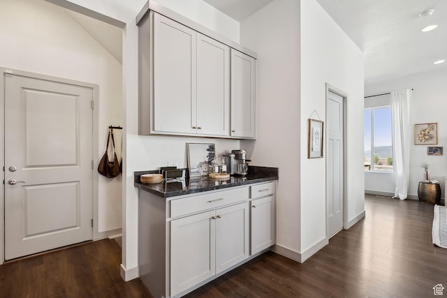 bar featuring baseboards, dark wood-type flooring, and recessed lighting