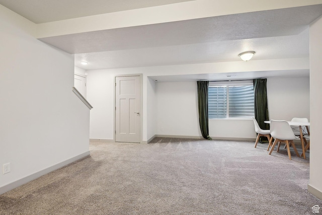 basement featuring baseboards and carpet
